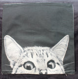 peering cat on linen